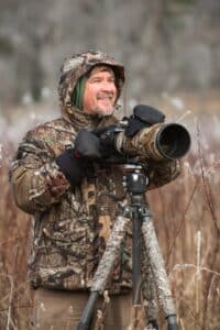 Chris Norcott with camera in field